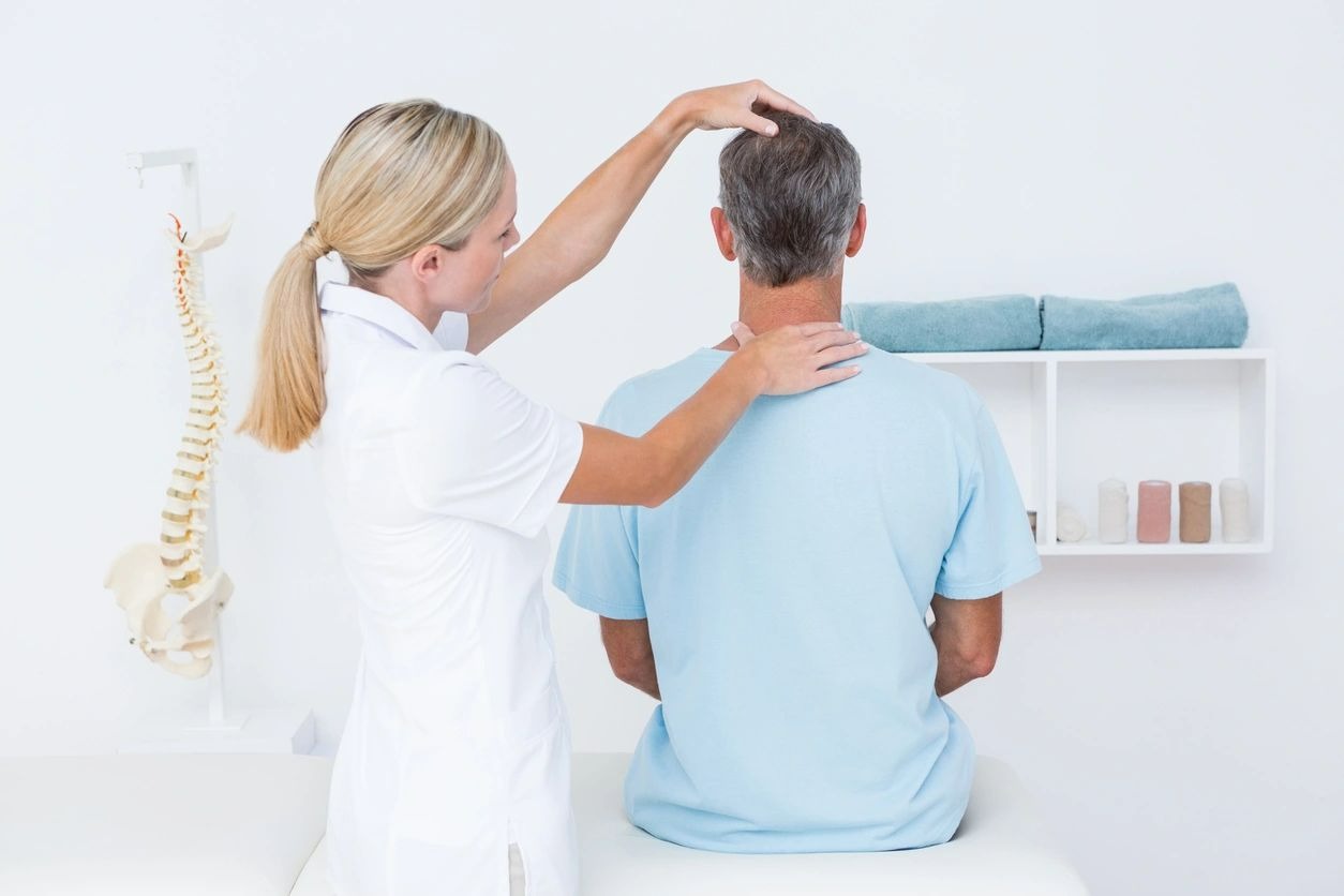 Doctor doing neck adjustment